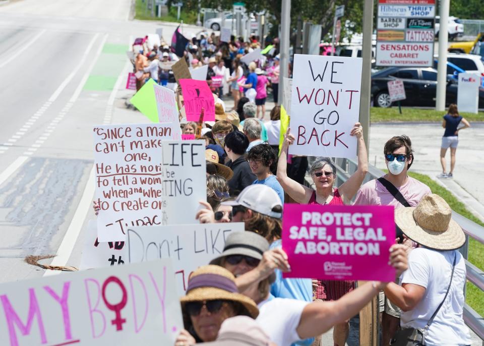 About a couple hundred people gather for the "We Dissent" protest on the Roosevelt Bridge on Sunday, June 26, 2022, in Stuart. The United States Supreme Court reversed its landmark 1973 decision in Roe v. Wade, which established a constitutional right to abortion, on Friday, June 24, 2022, leaving responsibility for the procedure's legality to the states.