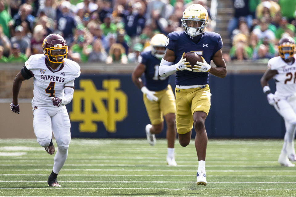 Notre Dame's Tobias Merriweather, right, secures a pass as he runs for a touchdown as Central Michigan's Donte Kent (4) chases him during the first half of an NCAA college football game on Saturday, Sept. 16, 2023, in South Bend, Ind. (AP Photo/Michael Caterina)