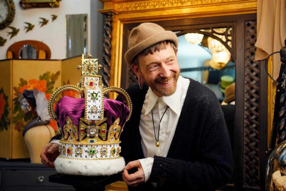 British milliner Justin Smith with a crown he has created using 319 Scrabble tiles (PA)