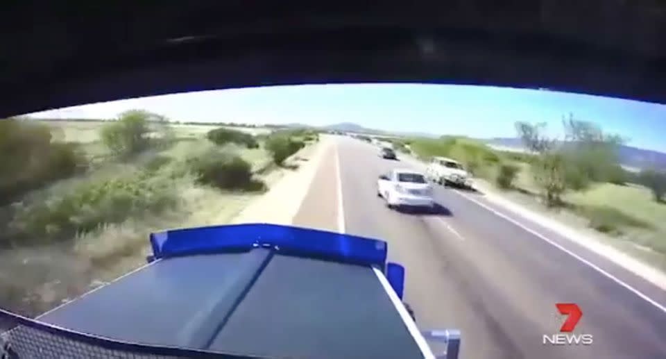 A driver cheats death overtaking a truck. Source: 7 News