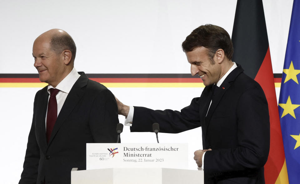 French President Emmanuel Macron, right, and German Chancellor Olaf Scholz leave after a joint press conference, Sunday, Jan. 22, 2023 at the Elysee Palace in Paris. France and Germany are seeking to overcome differences laid bare by Russia's war in Ukraine and shore up their alliance with a day of ceremonies and talks Sunday on Europe's security, energy and other challenges. (Benoit Tessier, Pool via AP)