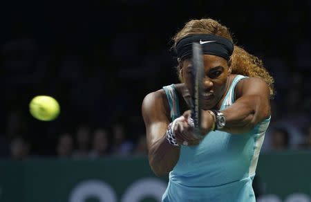 Serena Williams of the U.S. hits a return to Eugenie Bouchard of Canada during their WTA Finals singles tennis match at the Singapore Indoor Stadium October 23, 2014. REUTERS/Edgar Su