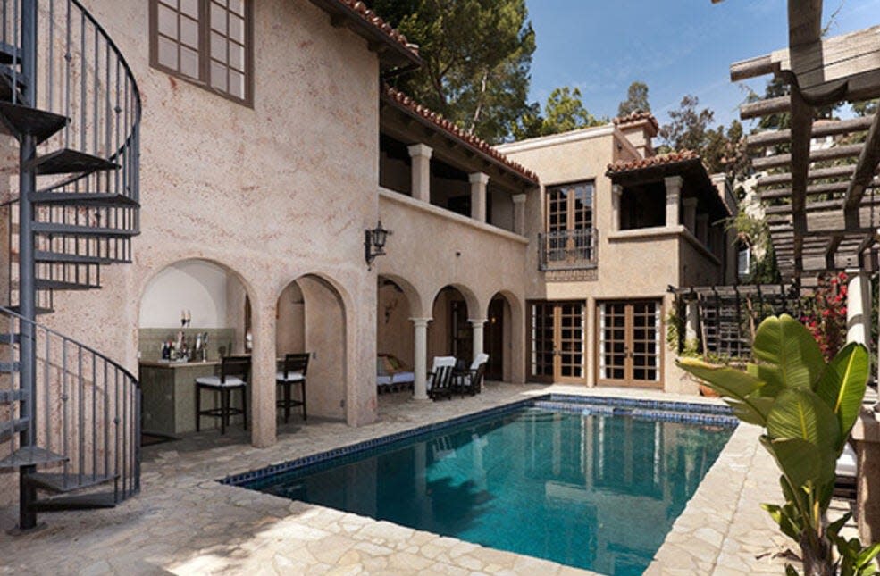 The entertaining area with pool, spa, wet bar and fireplace. Pictures taken before the "squatters" moved in.