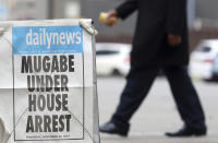 <p>A person passes a newspaper headline in Harare, Zimbabwe, Thursday, Nov. 16, 2017. (Photo: AP) </p>