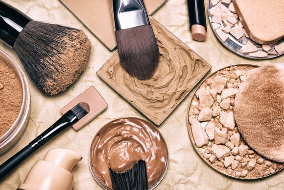 Close-up of an assortment of cosmetics products and brushes