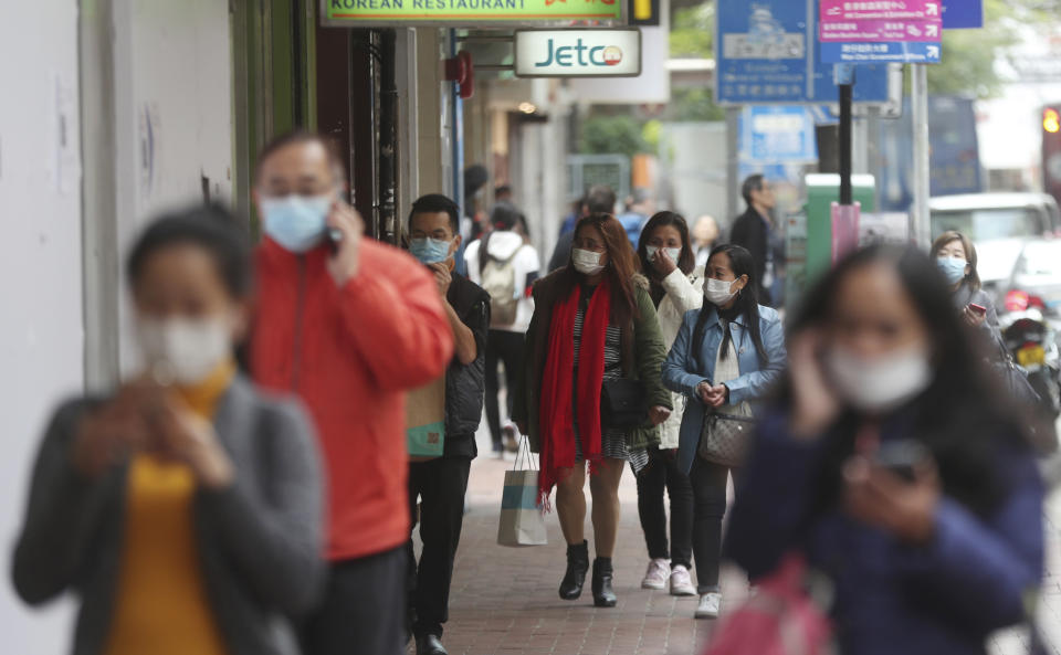 People wear masks in Hong Kong, Tuesday, Jan. 28, 2020. China has confirmed more than 4,500 cases of a new virus. Most have been in the central city of Wuhan where the outbreak began in December. More than 45 cases have been confirmed in other places with nearly all of them involving Chinese tourists or people who visited Wuhan recently. (AP Photo/Achmad Ibrahim)