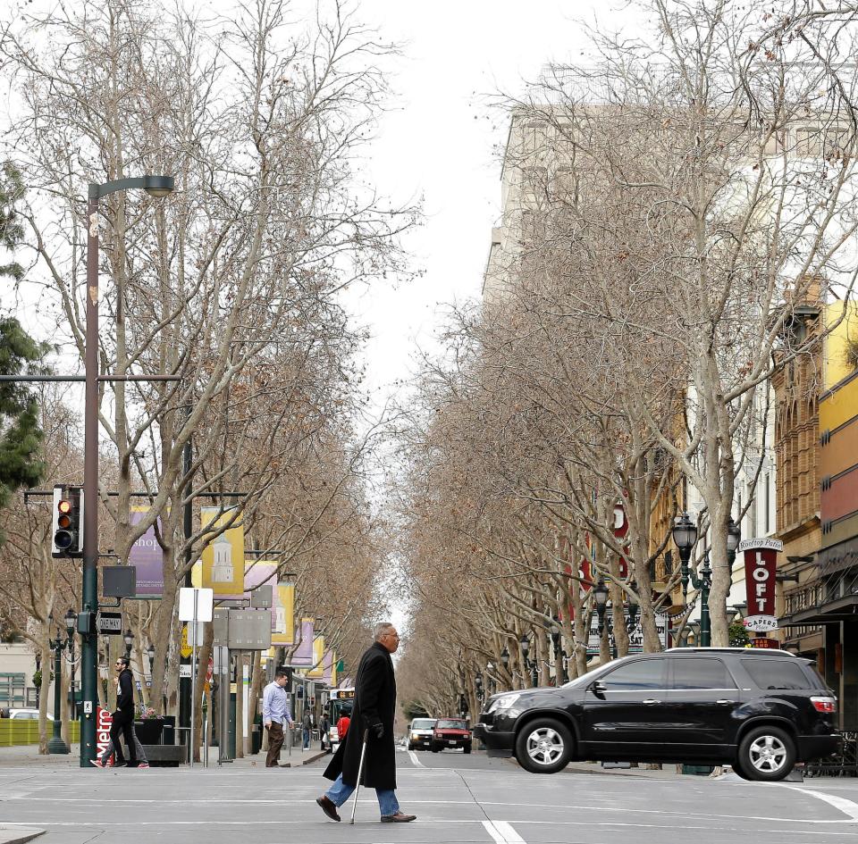 A man crosses Second Street in San Jose, California.