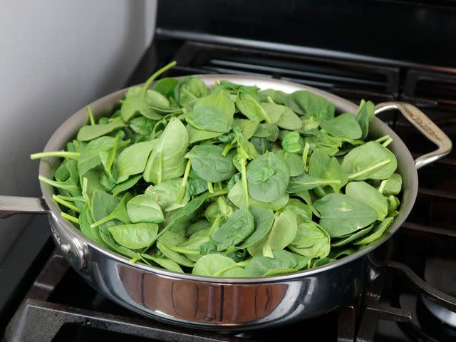 <p>Serious Eats / Jesse Raub</p> The All-Clad pan had the widest cooking surface and could easily accommodate a full clamshell of spinach.