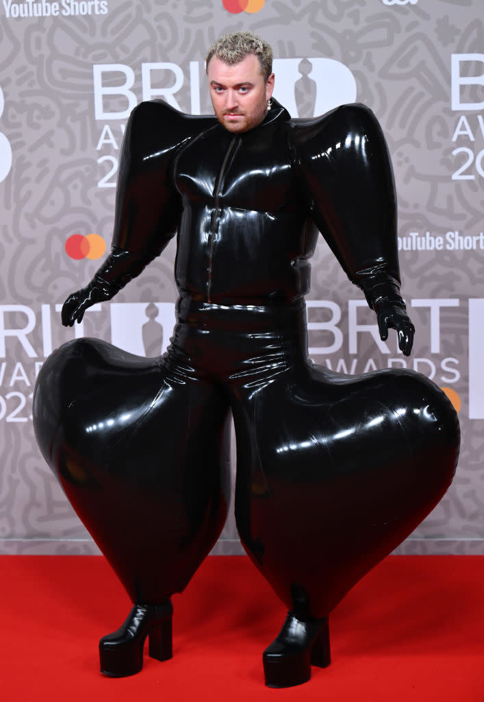 Sam Smith wears a latex jumpsuit puffed out at the shoulders and legs. 
