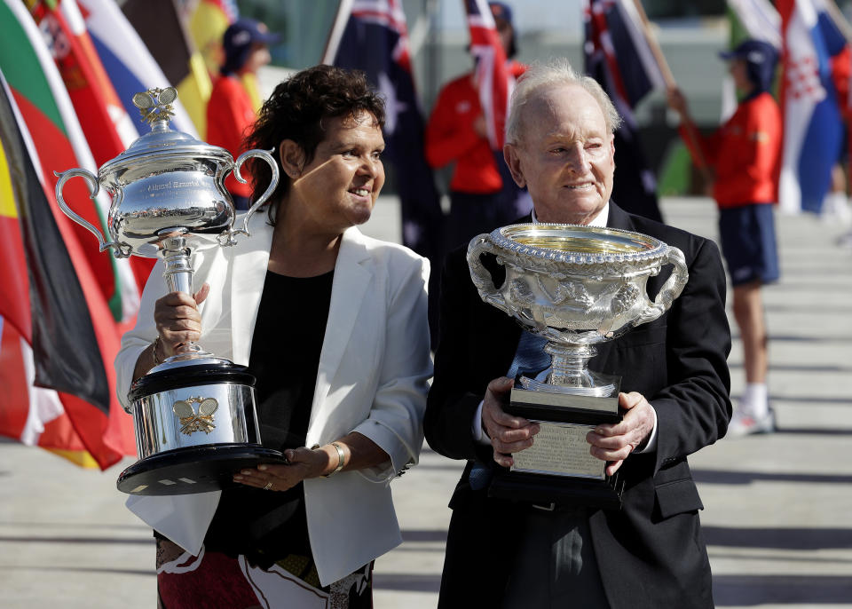 FILE - In this Jan. 14, 2019, file photo, Australian tennis legends Evonne Goolagong Cawley and Rod Laver hold the women's and men's trophies, the Daphne Akhurst Memorial Cup and the Norman Brookes Challenge Cup at the official start of the Australian Open tennis championships in Melbourne, Australia. Goolagong Cawley says fellow indigenous athlete Ashleigh Barty’s first Grand Slam singles title at the French Open was “a joy to watch.” (AP Photo/Aaron Favila, File)