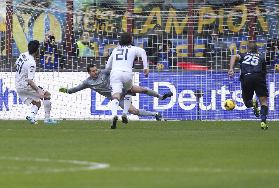 Cagliari forward Mauricio Pinilla, left, of Chile, scores on a penalty kick during the Serie A soccer match between Inter Milan and Cagliari at the San Siro stadium in Milan, Italy, Sunday, Feb. 23, 2014. (AP Photo/Antonio Calanni)