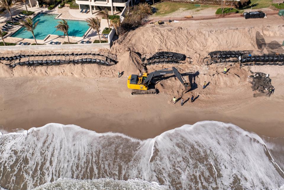 Crews bag sand to repair the eroded dunes on February 20, 2024 on Singer Island in Riviera Beach, Florida.