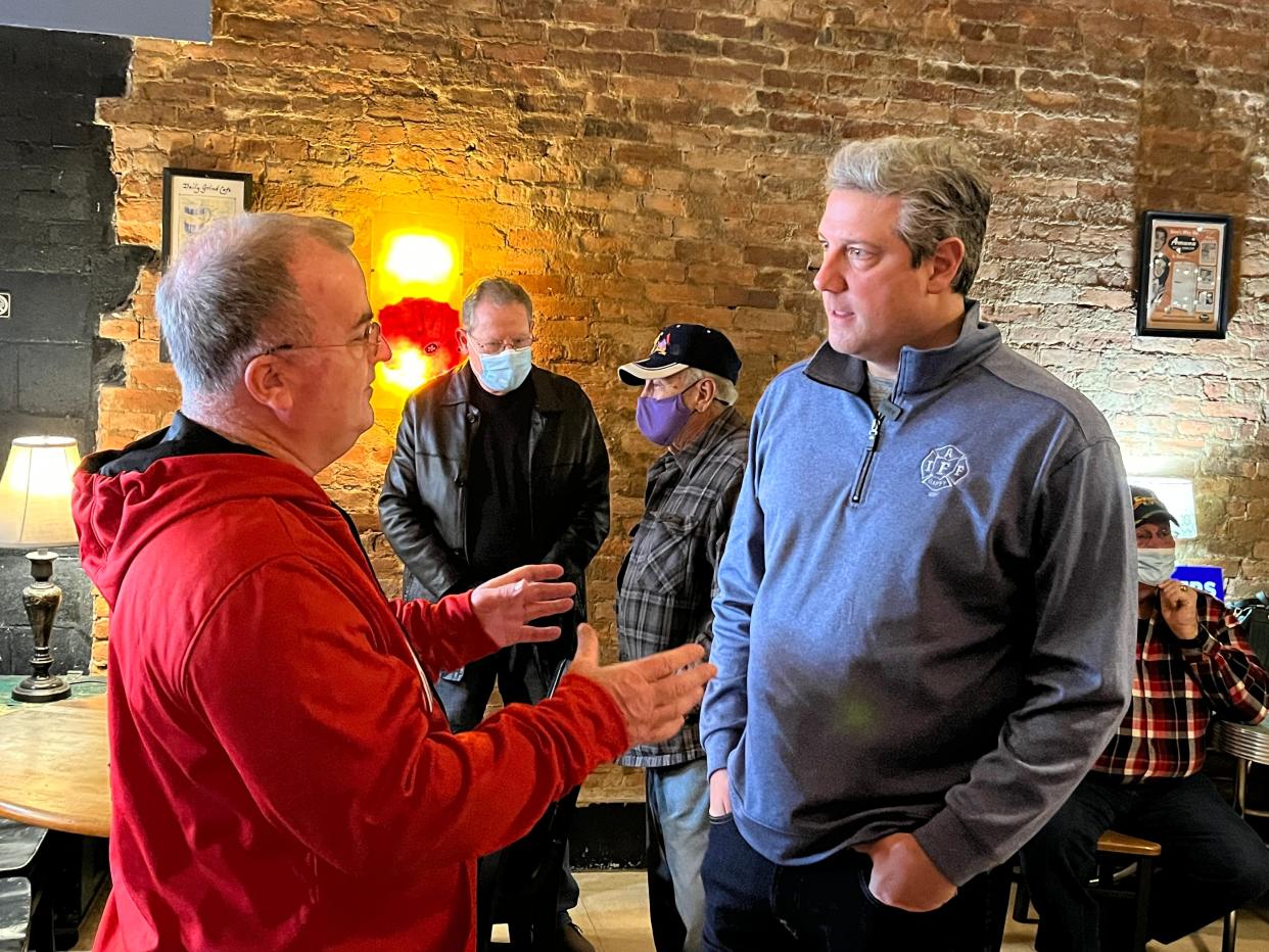 U.S. Rep. Tim Ryan, D-Niles, (Right) speaks with a Tuscarawas County resident Friday at the Daily Grind in New Philadelphia during a campaign visit.