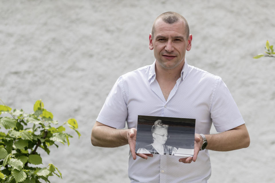 In this picture taken, April 24, 2020, José Miguel Cruz da Costa holds a photograph of his grandmother Hannelore Fischer Cruz singing in Braga, northern Portugal. Born amid the ruins of wartime Vienna, Hannelore Fischer was sent as a small child to Portugal where her flamboyant manner and outstanding soprano voice would later help her build a life far from her place of birth. She died of COVID-19 on March 25, 2020, after four days on a ventilator at Braga's hospital. (AP Photo/Luis Vieira)