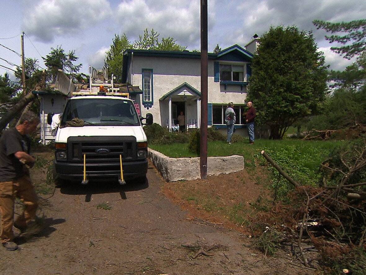 Sainte-Adèle resident Michel Tétreault, left, has been without electricity since Saturday when a storm knocked down several power lines in his town. (CBC - image credit)