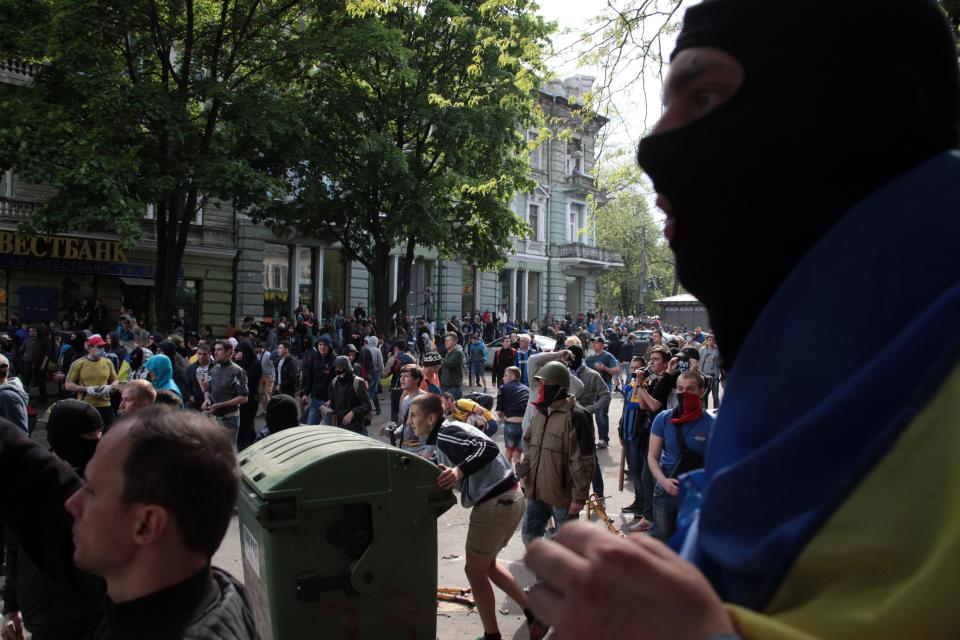 Ukrainian government supporters clash with pro-Russians in the Black Sea port of Odessa, Ukraine, Friday, May 2, 2014. A clash broke out late Friday between pro-Russians and government supporters in Odessa, on the Black Sea coast some 550 kilometers (330 miles) from the turmoil in the east. Odessa had remained largely untroubled by unrest since the February toppling of pro-Russia President Viktor Yanukovych, which ignited tensions in the east. (AP Photo/Sergei Poliakov)