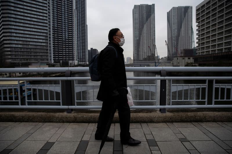 Man wearing a face mask, following an outbreak of the coronavirus, is seen on a street in Tokyo