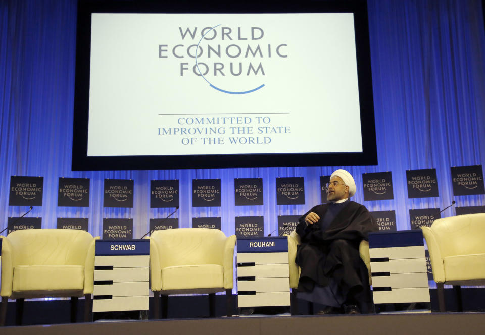 Iranian President Hassan Rouhani is listening to the welcome remarks during a session of the World Economic Forum in Davos, Switzerland, Thursday, Jan. 23, 2014. Leaders gathered in the Swiss ski resort of Davos have made it a top priority to push to reshape the global economy and cut global warming by shifting to cleaner energy sources. (AP Photo/Michel Euler)