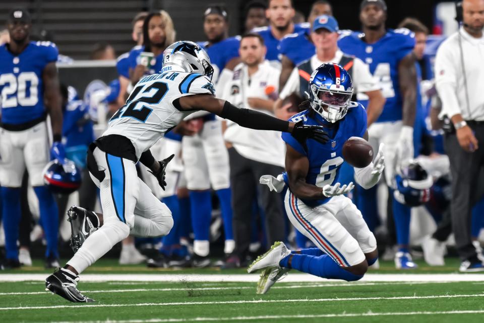 Aug 18, 2023; East Rutherford, New Jersey, USA; New York Giants wide receiver Bryce Ford-Wheaton (6) makes a catch as Carolina Panthers safety Sam Franklin Jr. (42) defends during the third quarter at MetLife Stadium. Mandatory Credit: John Jones-USA TODAY Sports