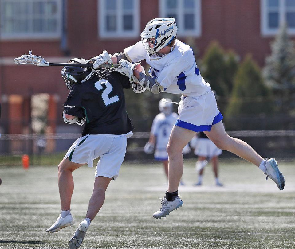 Clipper Oliver Rice takes a shot over Rams Nic Cupples.Marshfield lacrosse hosted Norwell in the "Chowda Cup" semifinals on Thursday April 20, 2023 