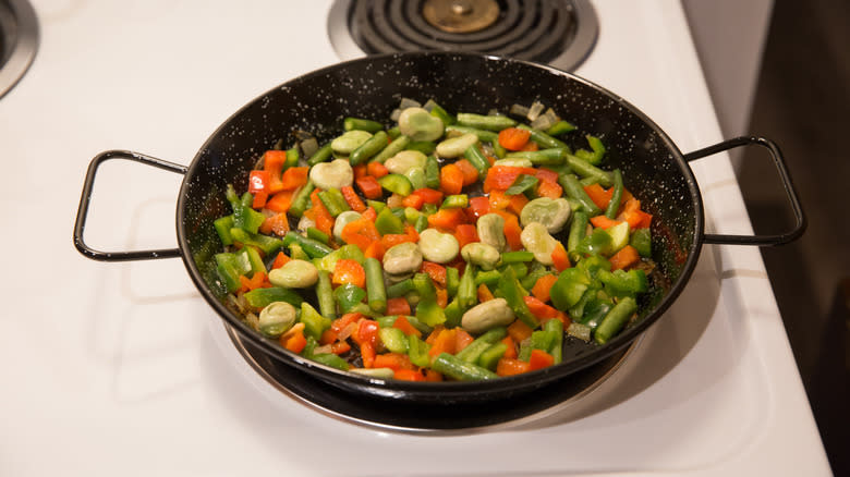 vegetables cooking in paella pan 