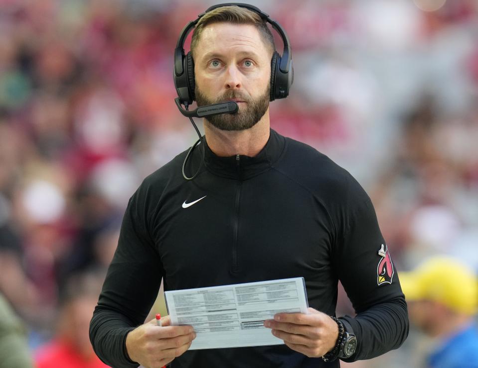 Kliff Kingsbury walks the sidelines as the Arizona Cardinals play the Seattle Seahawks at State Farm Stadium.