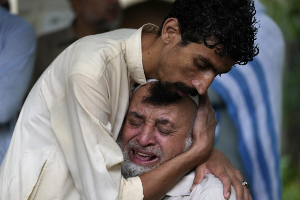 A man cries outside the mortuary after he lost his son in monsoon rains on the outskirts of Islamabad, Pakistan, Wednesday, July 19, 2023. (AP Photo/Rahmat Gul)