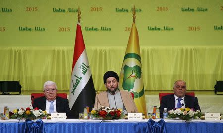 Iraq's President Fouad Massoum (L), Prime Minister Haider al-Abadi (R) and Ammar al-Hakim (C), leader of the Islamic Supreme Council of Iraq (ISCI), attend a conference dialogue among religious sects in Baghdad January 31, 2015. REUTERS/Khalid al-Mousily