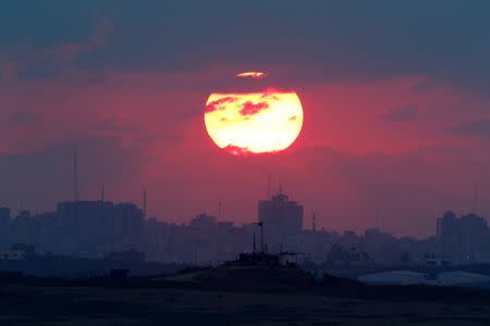The sun sets over the Gaza Strip, as seen from the Israeli side, September 8, 2016. REUTERS/Amir Cohen TPX IMAGES OF THE DAY