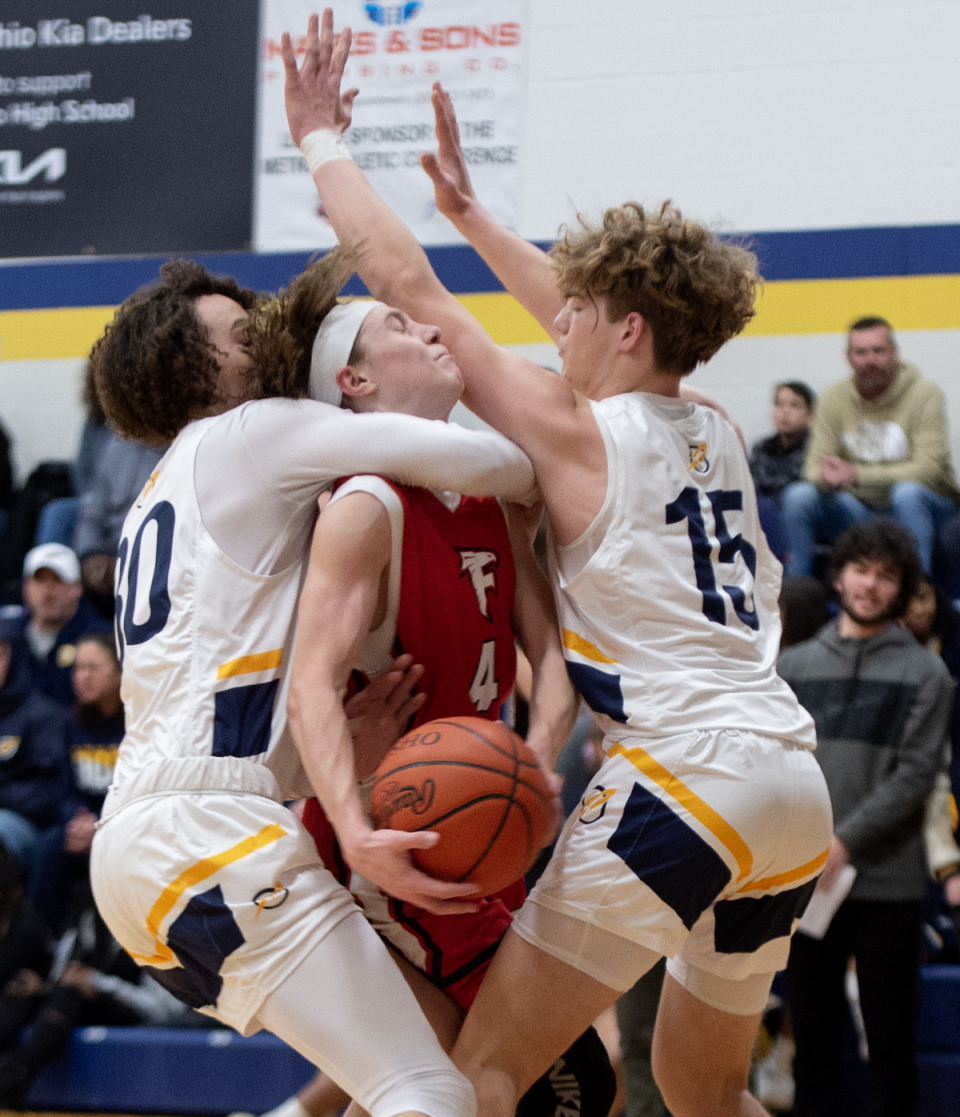 Michael Berry and Jackson Gula wrap up Grady Eader as his tries to take a shot.