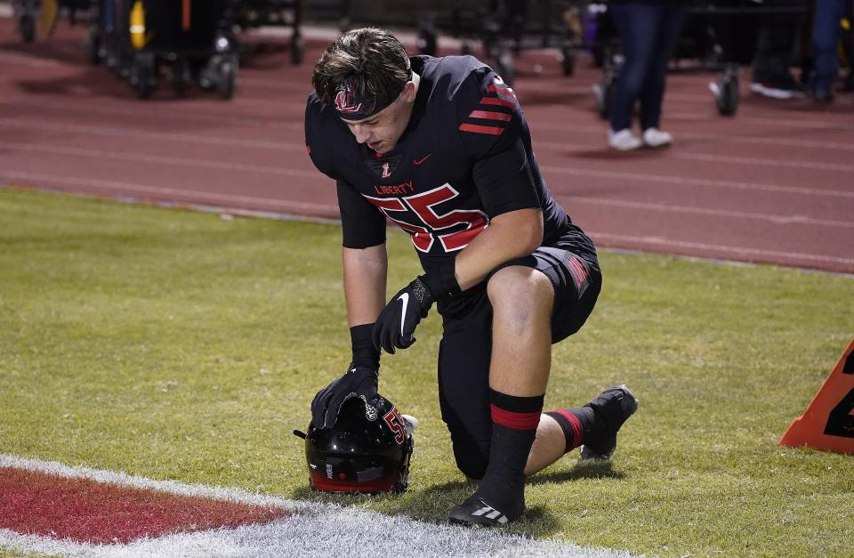 Liberty's Layton Vining has a moment to himself before their game against Queen Creek on Oct. 15, 2021, in Peoria.