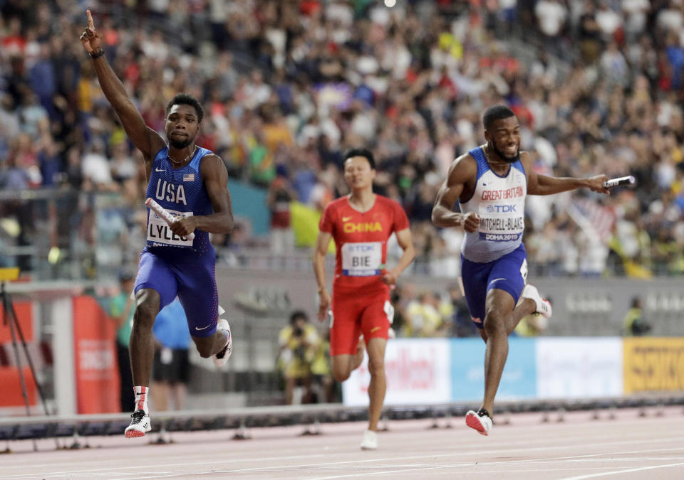 Noah Lyles of the United States, left, celebrates after leading the team to gold in the men's 4x100 meter relay final at the World Athletics Championships in Doha, Qatar, Saturday, Oct. 5, 2019. (AP Photo/Petr David Josek)