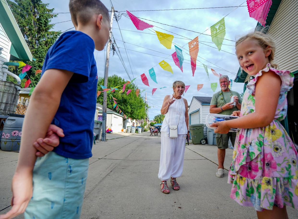 Susan Ballje, middle, and Bill Koehn, right, greet guests as they arrive for the National Night Out Block Party Friday, Aug. 12, 2022, located near 1707 E. Iron St., in the Bayview neighborhood.