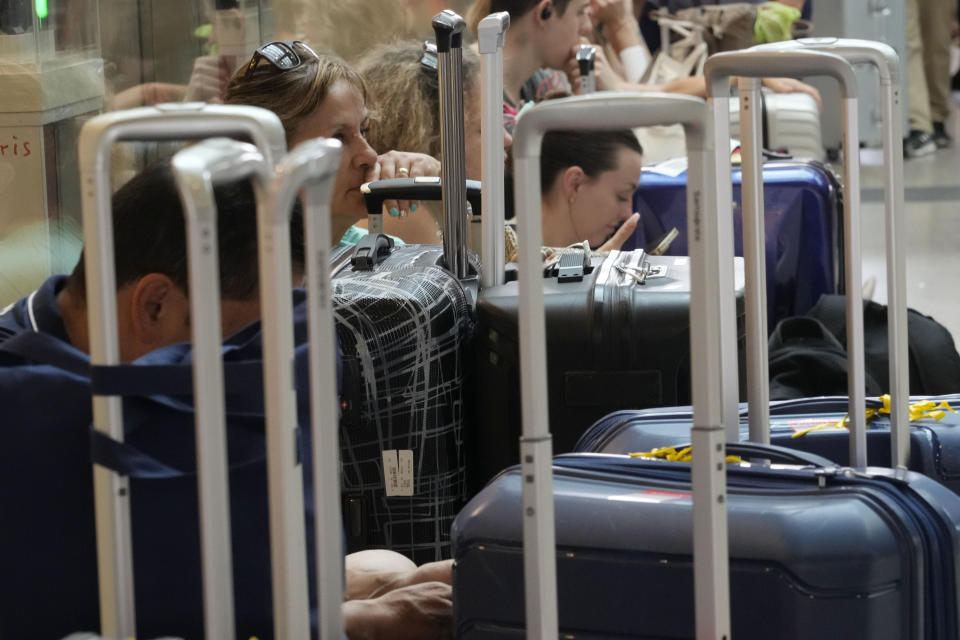 Passengers wait for their trains at Rome's termini central station during a national train strike, Thursday, July 13, 2023. Trenitalia and Italo train workers are on strike to demand better working conditions and training. (AP Photo/Gregorio Borgia)