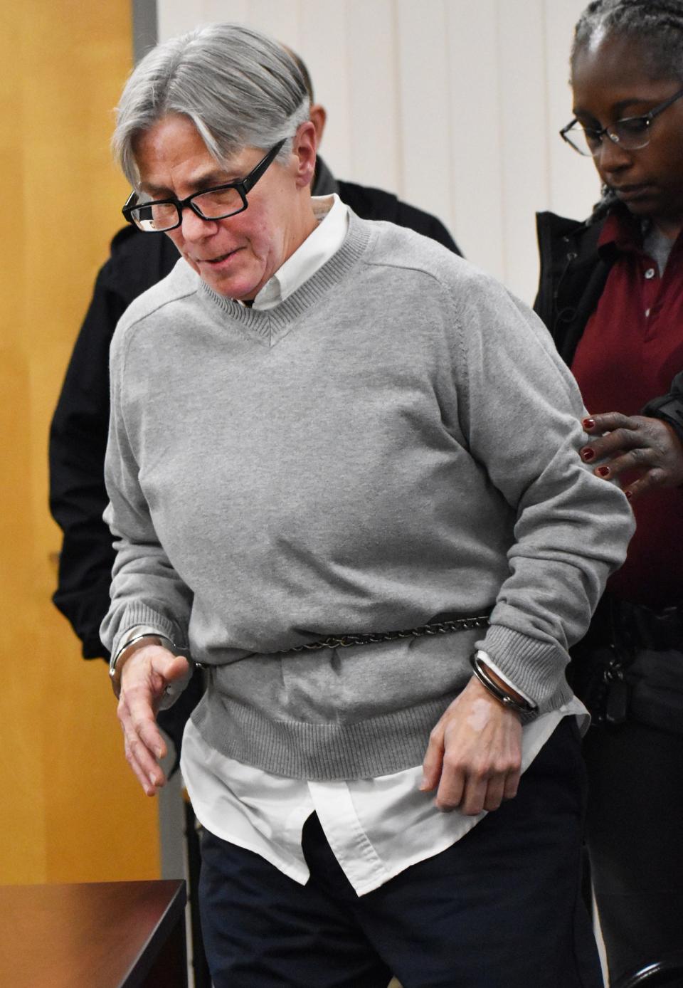 Convicted murderer Robin Murphy is led into her parole hearing in Natick on Tuesday, March 5, 2024.