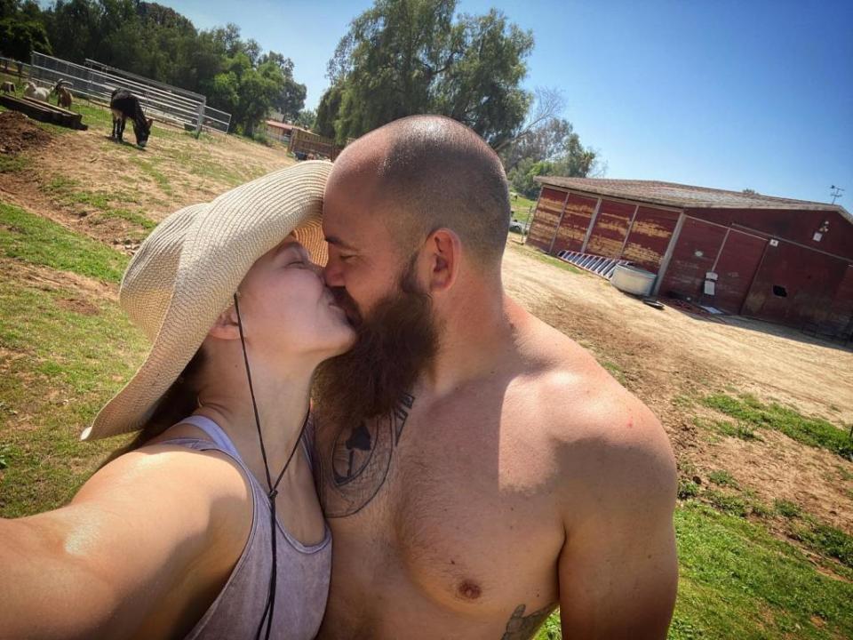 Rousey kisses Travis Browne, whom she married in 2017. Browsey Acers