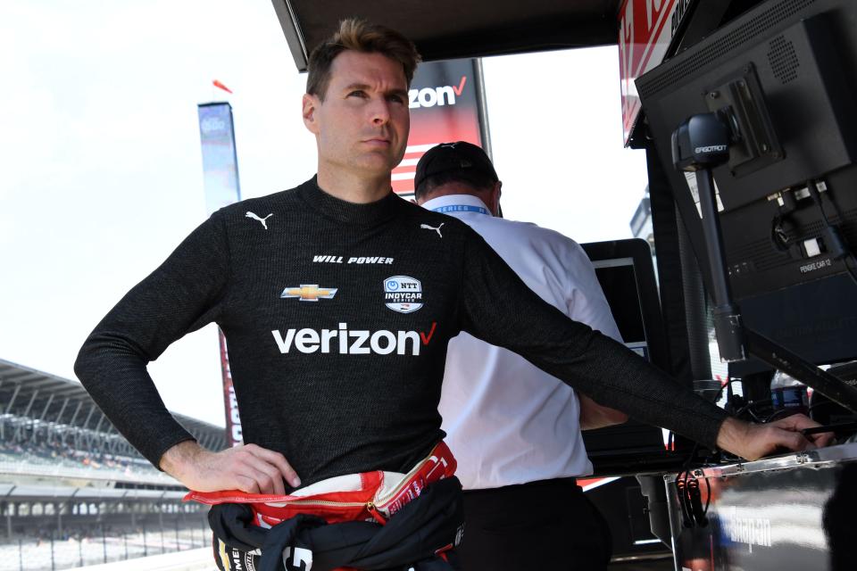 Team Penske driver Will Power stands in his pit box at Indianapolis Motor Speedway during Fast Friday practice in preparation for the 106th running of the Indianapolis 500.