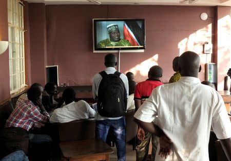 South Sudanese civilians watch Vice President Riek Machar speaking on a television set following renewed fighting in South Sudan's capital Juba, July 10, 2016. REUTERS/Stringer FOR EDITORIAL USE ONLY. NO RESALES. NO ARCHIVES. TPX IMAGES OF THE DAY