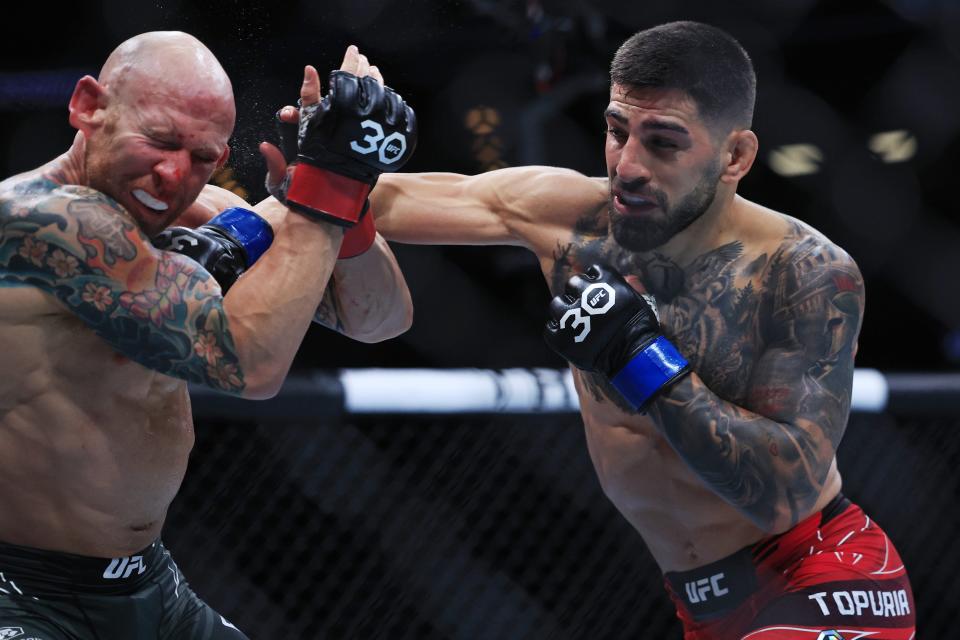 Ilia Topuria lands a punch on Josh Emmett in the main-event featherweight bout during UFC Fight Night Saturday at Jacksonville's VyStar Veterans Memorial Arena.