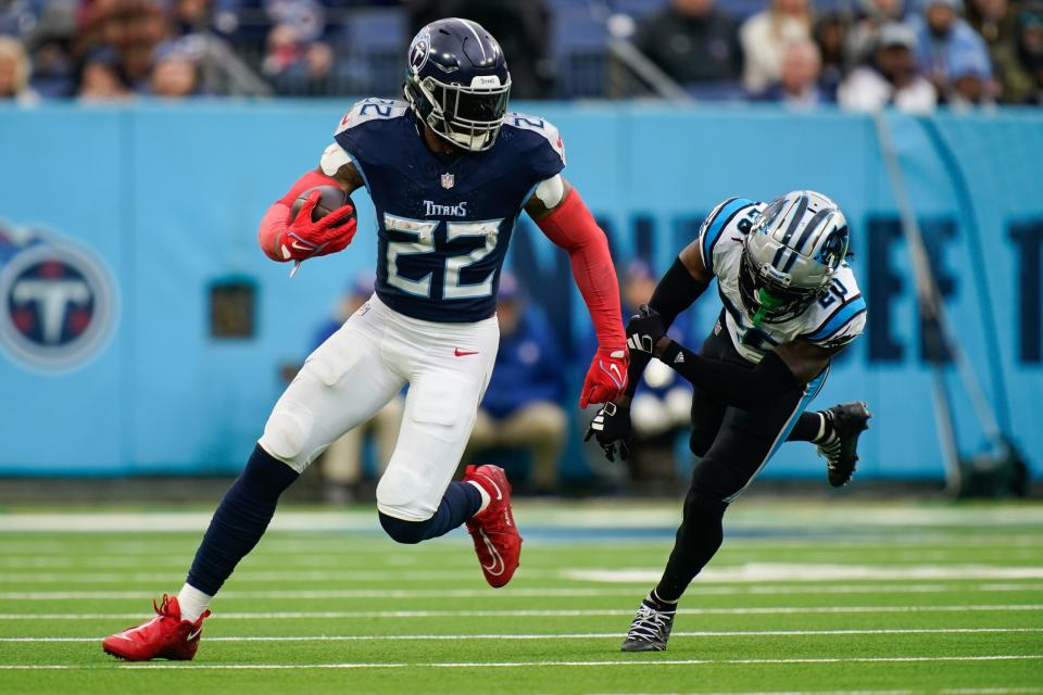 Tennessee Titans running back Derrick Henry (22) evades Carolina Panthers cornerback <a class="link " href="https://sports.yahoo.com/nfl/players/32020" data-i13n="sec:content-canvas;subsec:anchor_text;elm:context_link" data-ylk="slk:David Long Jr.;sec:content-canvas;subsec:anchor_text;elm:context_link;itc:0">David Long Jr.</a> (20) during the fourth quarter at Nissan Stadium in Nashville, Tenn., Sunday, Nov. 26, 2023.