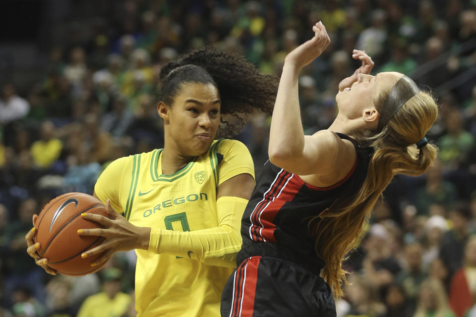 Oregon's Satou Sabally, left, picks up a player control foul against Utah's Dru Gylten during the second quarter of an NCAA college basketball game in Eugene, Ore., Sunday, Jan. 5, 2020. (AP Photo/Chris Pietsch)