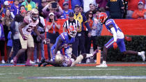 Florida State wide receiver Ontaria Wilson (80) can't make a reception in front of Florida cornerback Kaiir Elam (5) and cornerback Avery Helm, right, during the second half of an NCAA college football game, Saturday, Nov. 27, 2021, in Gainesville, Fla. (AP Photo/John Raoux)
