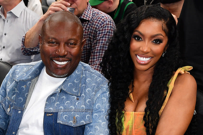 Porsha Williams and her husband Simon Guobadia sitting at an Atlanta hawks game together.