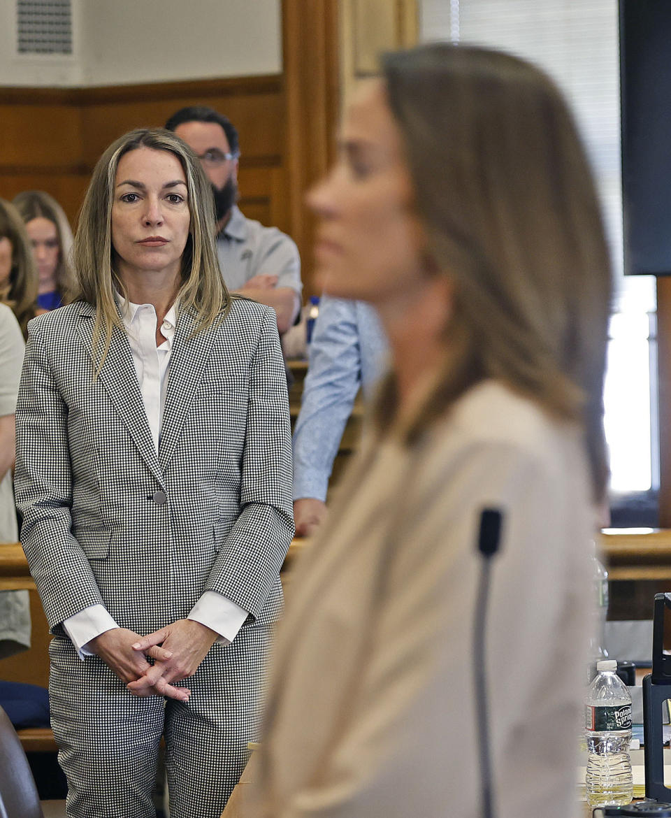 Defendant Karen Read, left, watches as witness Jen McCabe leaves the court after testifying in Read's murder trail, Wednesday, May 22, 2024,, at Dedham Superior Court in Dedham, Mass. Read is facing charges including second degree murder in the 2022 death of her boyfriend Boston Officer John O’Keefe. (Greg Derr/The Patriot Ledger via AP, Pool)