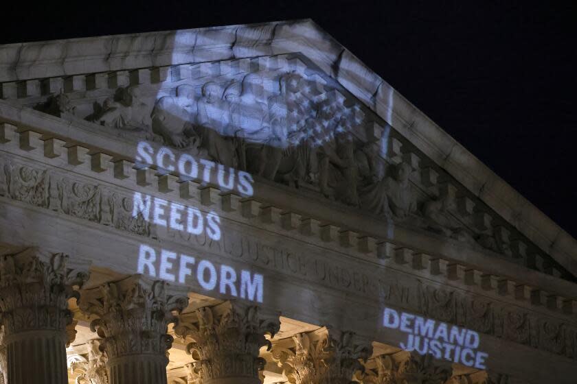 WASHINGTON, DC - MAY 21: Demand Justice projects "Stop The Steal" upside down American flag on the U.S. Supreme Court to call attention to Justice Alito's alleged actions on May 21, 2024 in Washington, DC. (Photo by Paul Morigi/Getty Images for Demand Justice)