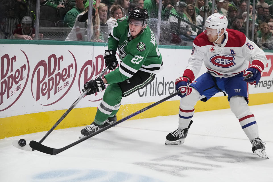 Dallas Stars left wing Mason Marchment (27) skates for the puck against Montreal Canadiens defenseman Mike Matheson (8) during the first period an NHL hockey game in Dallas, Tuesday, Jan. 2, 2024. (AP Photo/LM Otero)