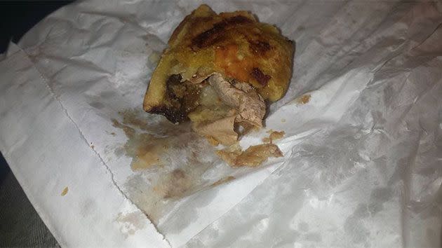The band-aid looks similar to a piece of meat. It is a fair flesh-coloured piece of plastic shown lodged right in the middle of the pie. Photo: Facebook/Brendon Humphreys