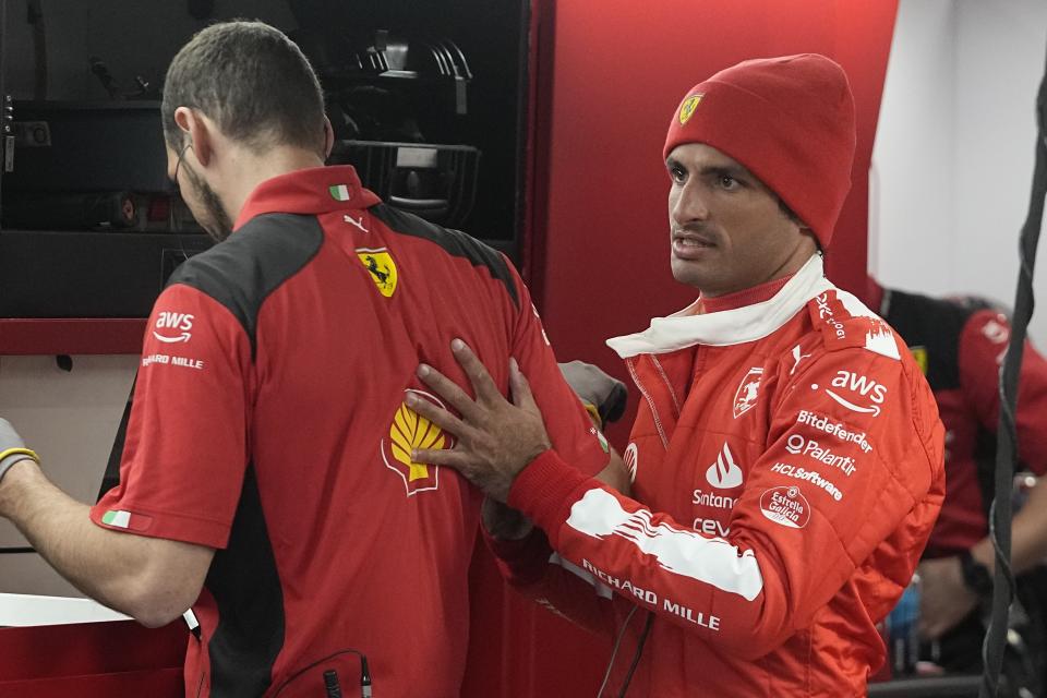 Ferrari driver Carlos Sainz, of Spain, talks with his a team member before the final practice session for the Formula One Las Vegas Grand Prix auto race, Friday, Nov. 17, 2023, in Las Vegas. (AP Photo/Darron Cummings)