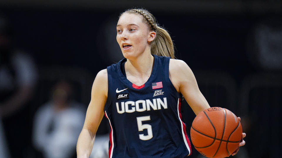 Connecticut guard Paige Bueckers (5) plays against Butler during the first quarter of an NCAA college basketball game in Indianapolis, Saturday, Feb. 27, 2021. (AP Photo/Michael Conroy)