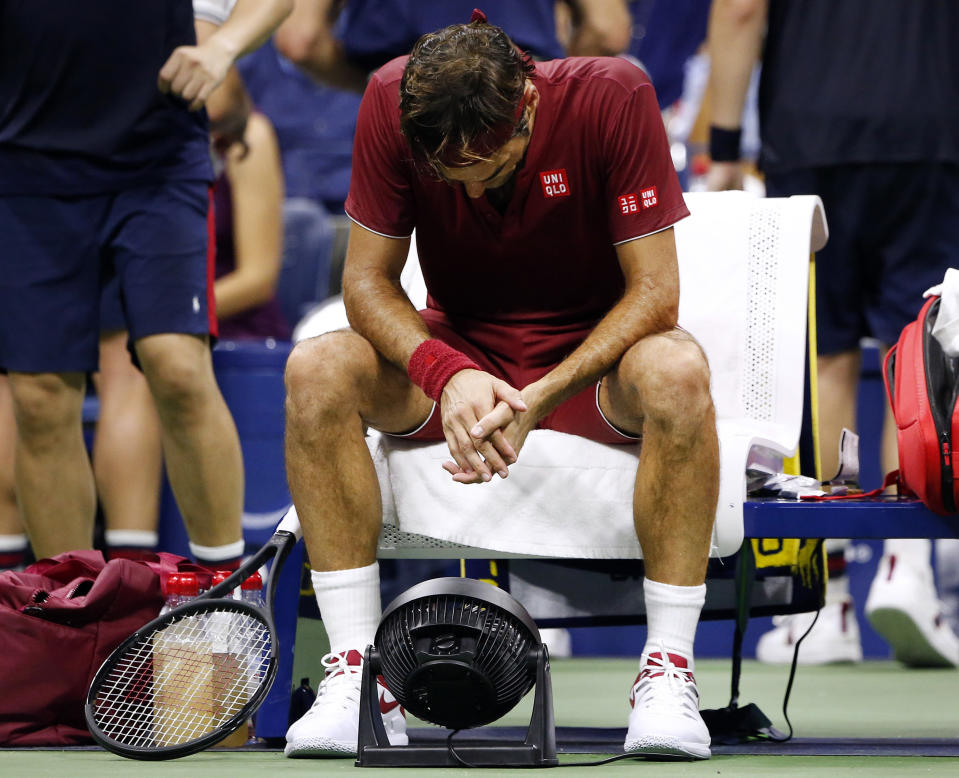 Roger Federer sits in front of a fan during a changeover in his match against John Millman. (AP)